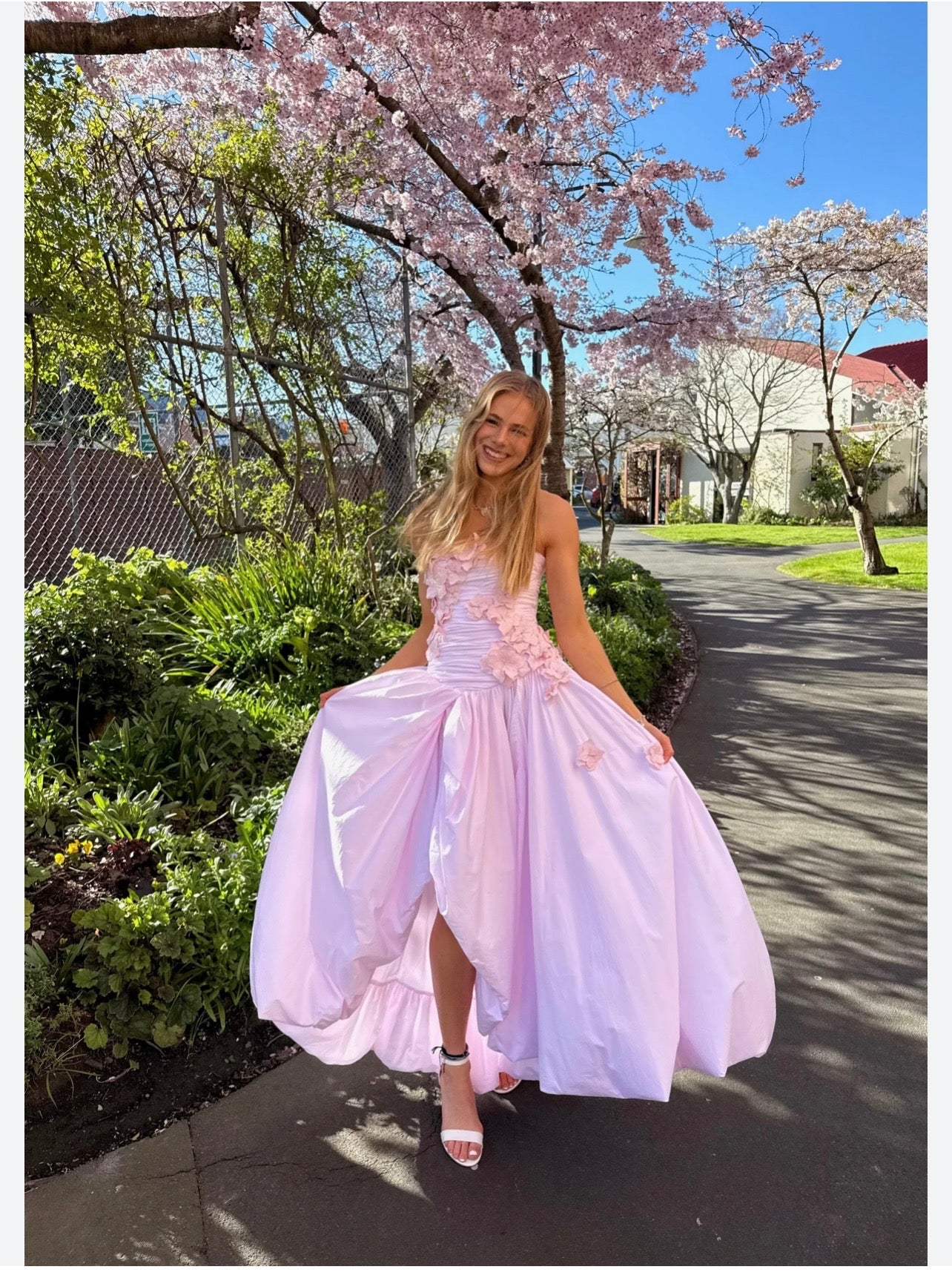 Pink strapless prom gown with 3D floral appliqué bodice and voluminous taffeta ball skirt with high slit