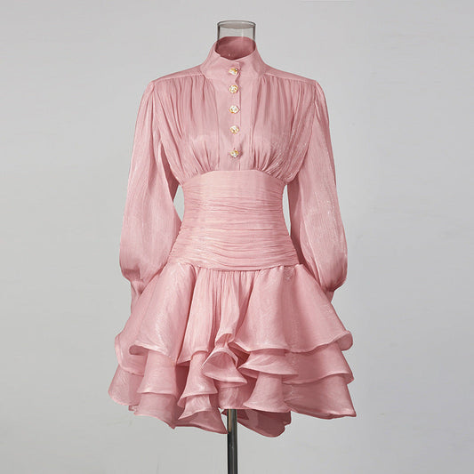 Pale pink shimmery long-sleeve high-neck mini dress with gold buttons, ruched waist and layered ruffle skirt
